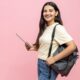 Cheerful,Young,Student,Girl,With,Backpack,Using,Digital,Tablet,For